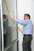 Scott Crumrine, director of capital projects for Atkore International, measures a spot for a LEED-CS Gold certification plaque in the vestibule of the company's Harvey, Ill., headquarters.