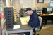 Warehouse associate Brian Gundersen sorts through order pick tickets and assigns them based on route numbers. Here he&rsquo;s pre-routing them based on city and address.