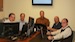 Paul Senecal, far left, and Michael Diamond, center, sitting at United Services of America’s corporate headquarters in Stamford, Conn., with Chief Administrative Officer Mario Tarantino, second from left, and CFO Gabor Elcsics and COO Aramis Cordal on the right.
