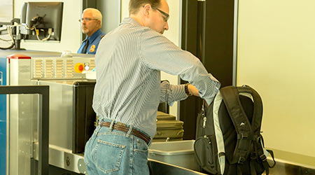 Airport TSA Bins Equipped With Self-Cleaning Mats