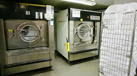 Laundry Workers Sue Over Wages, Warehouse Conditions