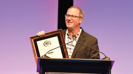 Man gives speech while accepting award