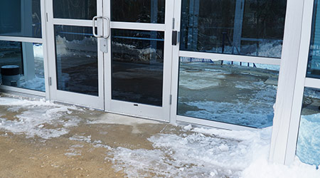 close up on office building door exterior with snow removed