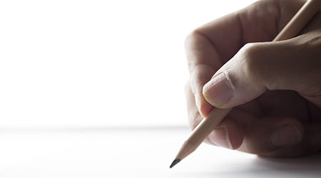 Hand holding pencil