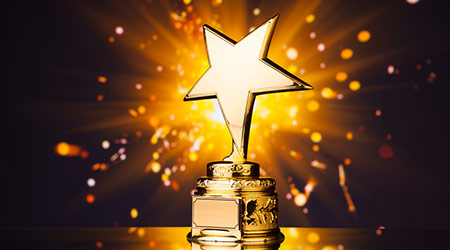 old star trophy against shiny sparks background