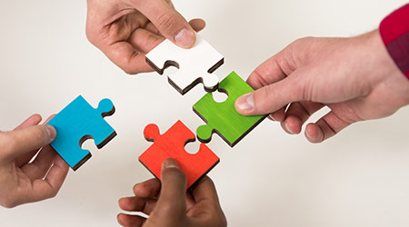 business people group assembling jigsaw puzzle and represent team support