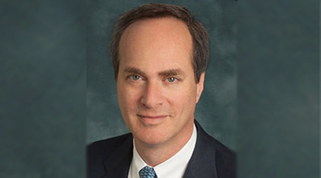 Man in suit and tie smirks for camera