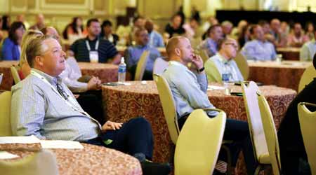 A crowd listens to a speaker