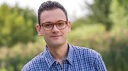 Man in glasses smirks
