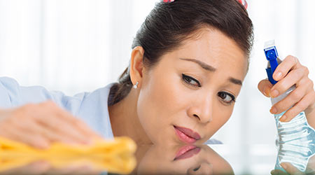 Woman cleaning the surface of the table with chemical and microfiber cloth                                                                            