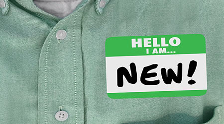 Name tag on dress shirt that reads "Hello I am New"