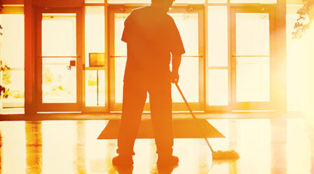 Janitor mopping in an office building