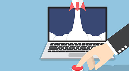 Businessman hand pushing the button to launch rocket from laptop monitor, startup business