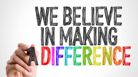 Hand with marker writing: We Believe in Making a Difference