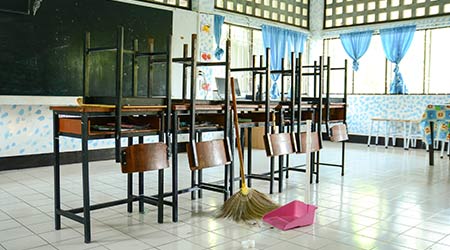 Classroom cleaning with a broom