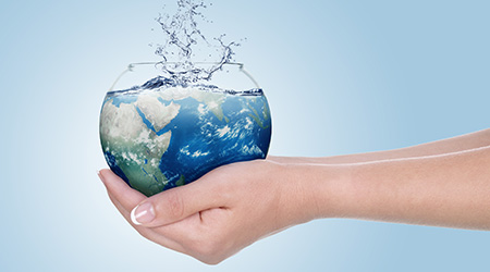 Globe in human hand against blue sky