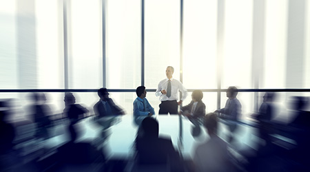 The leader of the business people giving a speech in a conference room