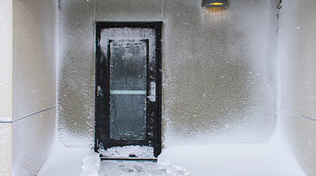 Building Entrance Door With Ice and Drifted Snow