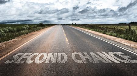"Second Chance" written in white on an empty road