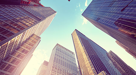 Vintage stylized photo of Manhattan skyscrapers at sunset, looking up perspective, New York City, USA.