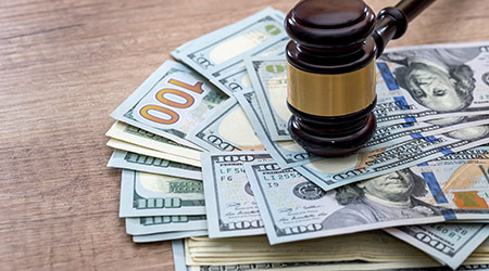 wooden gavel with usa dollar on desk. close up. macro