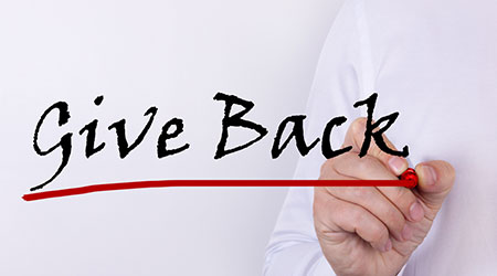 Hand writing inscription give back with marker concept