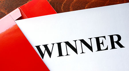 Paper with word winner and red envelope