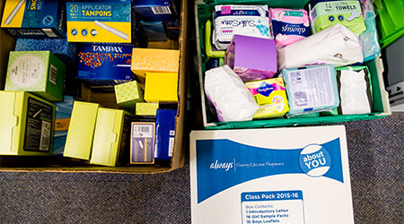 ROTHERHAM, ENGLAND - MAY 31, 2018: A local church food bank (part of Trussell Trust) dealing with period poverty - a selection of the sanitary products that have been donated in boxes for distribution
