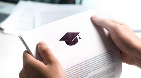 College or university application or letter from school. Student or teacher reading education document. Young man holding grant, graduation, study loan or scholarship paper.