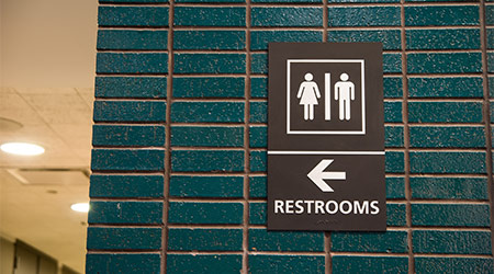 A sign pointing to public restrooms