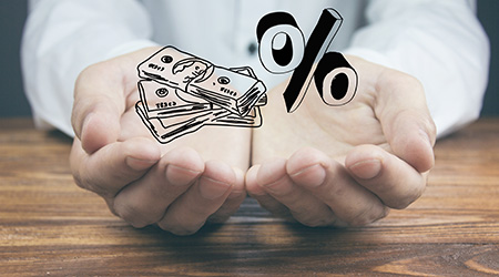a hand holding a sketch of money and a percent sign
