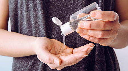 person applying hand sanitizer