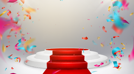 Illuminated stage podium with confetti and red carpet.