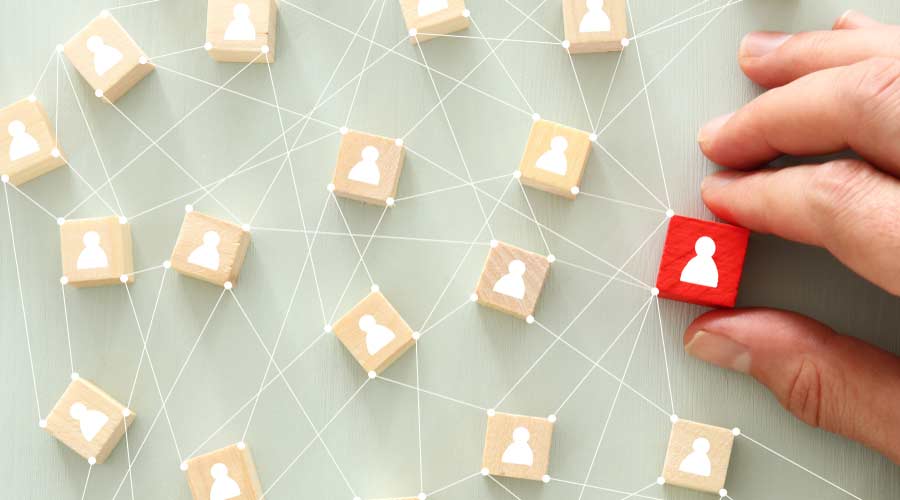 image of wooden blocks with people icon over mint table,building a strong team, human resources and management concept - Image