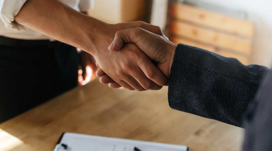 Partnership. two business people shaking hand after business signing contract in meeting room at company office, job interview, investor, success, negotiation, partnership, teamwork, financial concept