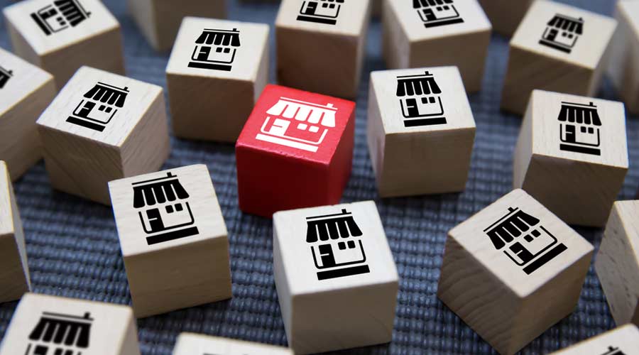 Franchise business on Cubes wood concept or wooden blog with franchise marketing store icons for Business Growth,Credit approval for business expansion.