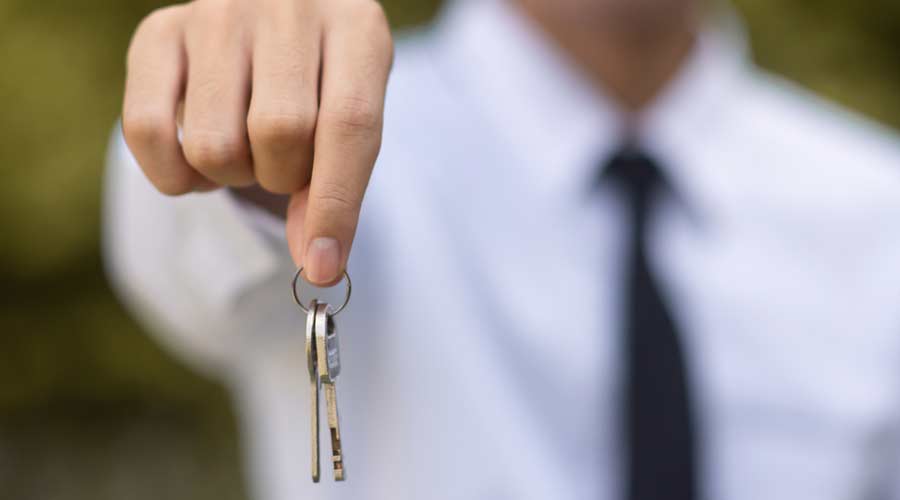Hand holding key house concept business investment real estate rent finance load