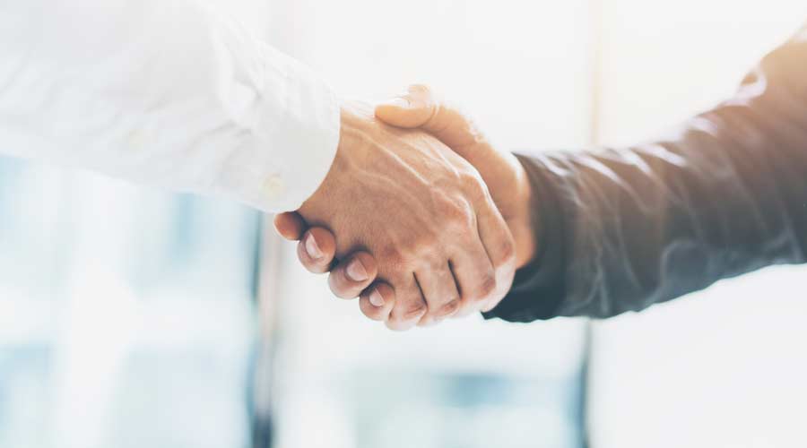 Business partnership meeting. Picture businessmans handshake. Successful businessmen handshaking after good deal. Horizontal, blurred background