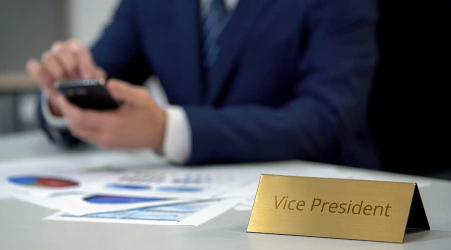 Company vice president using mobile app for working on documents, calculating
