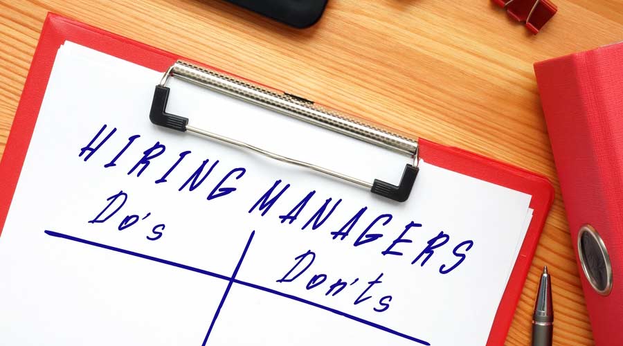 Business concept meaning HIRING MANAGERS Do's and Don'ts with inscription on the piece of paper.
