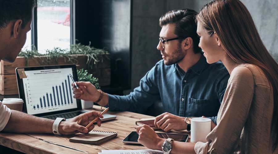Business professionals. Group of young confident business people analyzing data using computer while spending time in the office