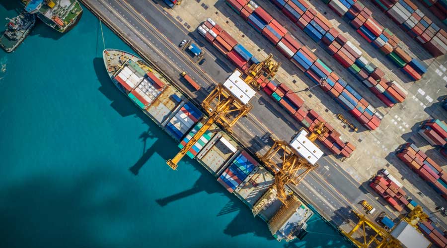 Logistics and transportation of Container Cargo ship and Cargo plane with working crane bridge in shipyard, logistic import export and transport industry background
