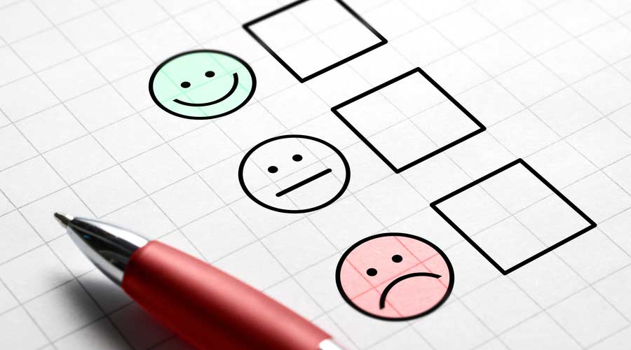 Customer satisfaction survey and questionnaire concept. Giving feedback with multiple choice form. Pen, paper and emotion smiley face icons.