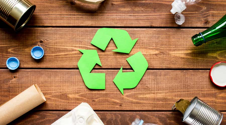 Eco concept with recycling symbol on table background top view