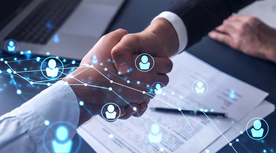 Recruitment concept to hiring of a new talented specialists for international company. Handshake to sign in of employment agreement. Social media hologram icons over the table with documents.