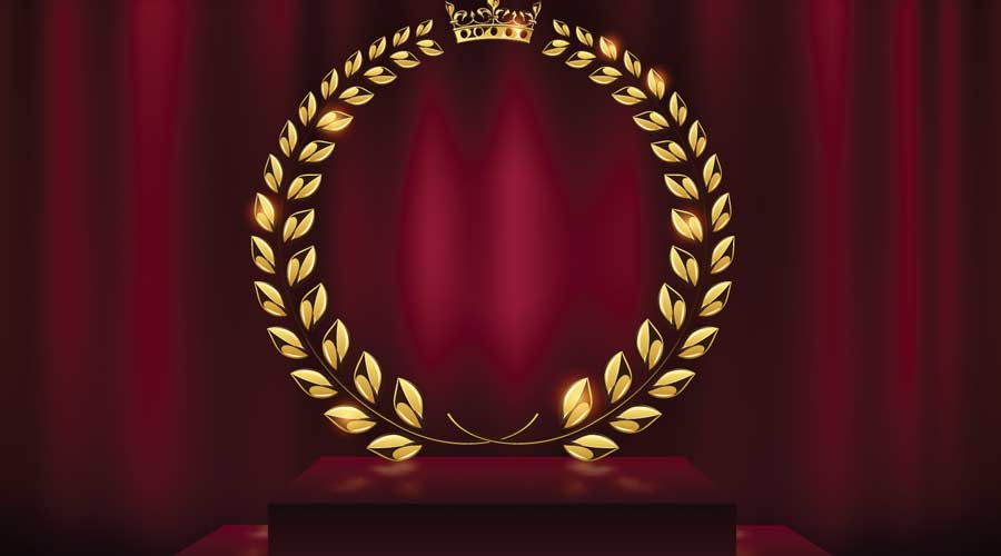 A detailed golden laurel wreath award on a velvet red curtain background and podium.  Gold ring frame logo.  Victory, honor, success, quality product, anniversary.  An example of a vector