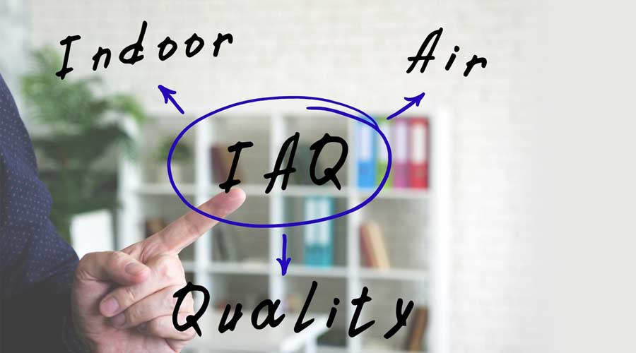 IAQ Indoor Air Quality written text. Hand gestures - man pointing on virtual object on officce background.