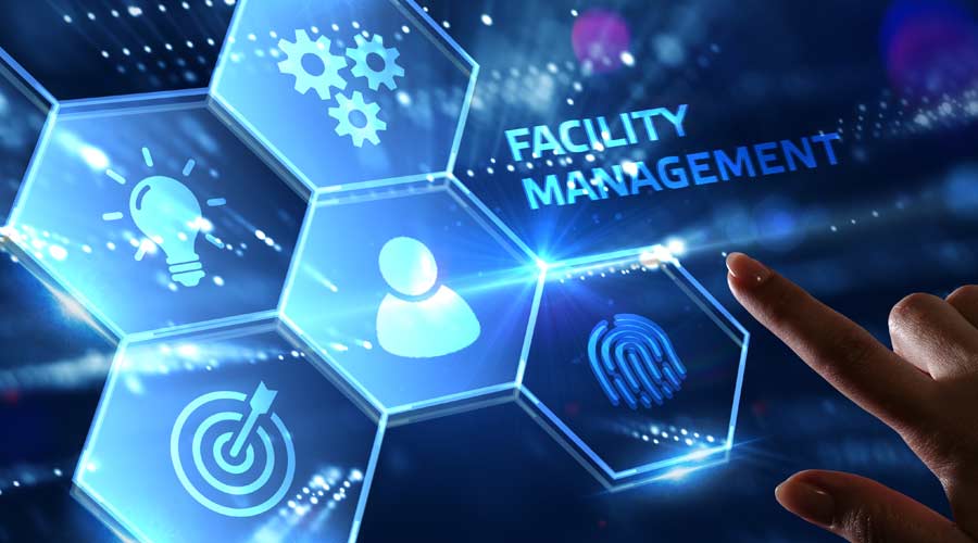 Business, Technology, Internet and network concept. Young businessman shows the word on the virtual display of the future: Facility management