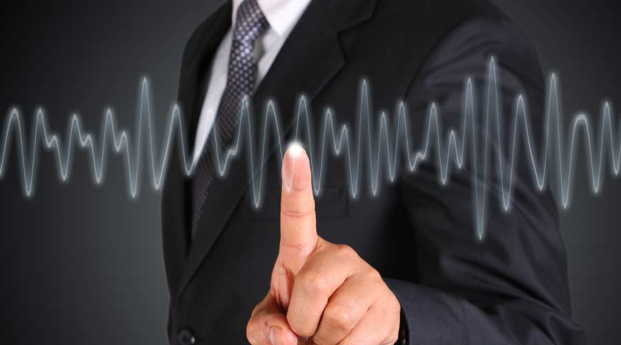 Business man touching screen, symbolising Keeping your finger on the pulse.