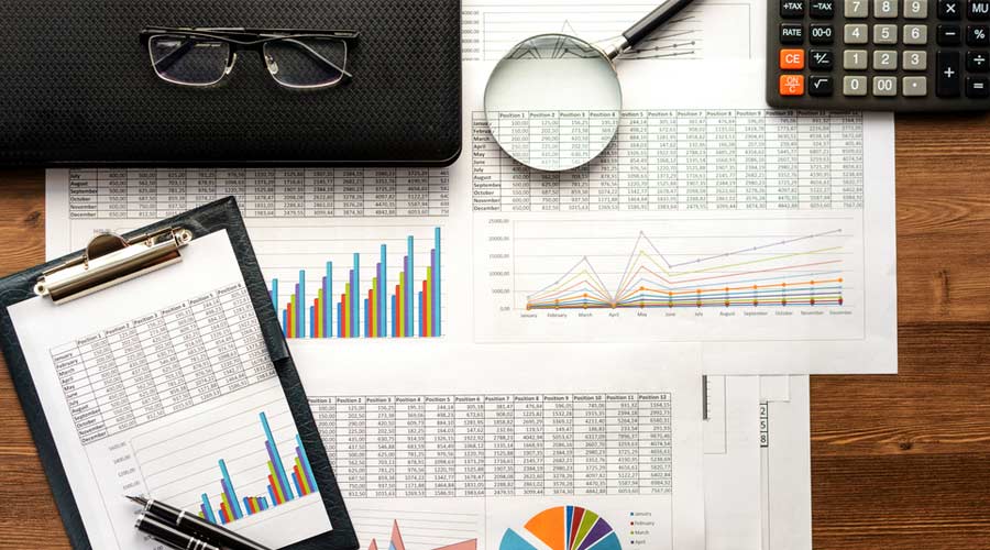 Financial printed paper charts, graphs,calculations, calculator and diagrams